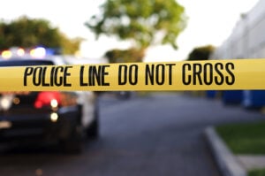 Caution tape near a police car indicative of a forensic nursing work space