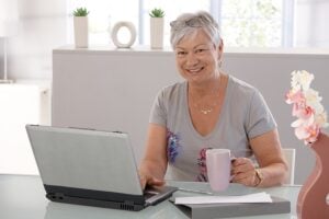 Retired nurse at computer